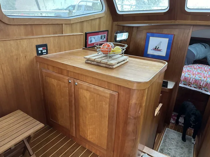 Blue Goose Yacht Photos Pics Interior of 2003 Sabre 36 Fly Bridge Sedan with wooden cabinetry and fruit basket.