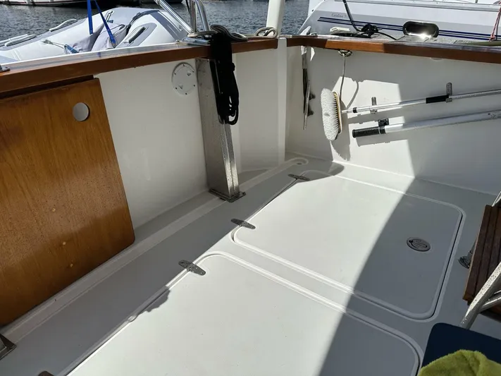 Blue Goose Yacht Photos Pics 2003 Sabre 36 Fly Bridge Sedan boat deck with clean white surface and wooden accents.