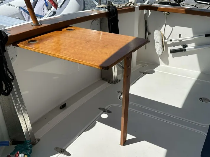 Blue Goose Yacht Photos Pics 2003 Sabre 36 Fly Bridge Sedan cockpit with wooden table and cleaning tools.