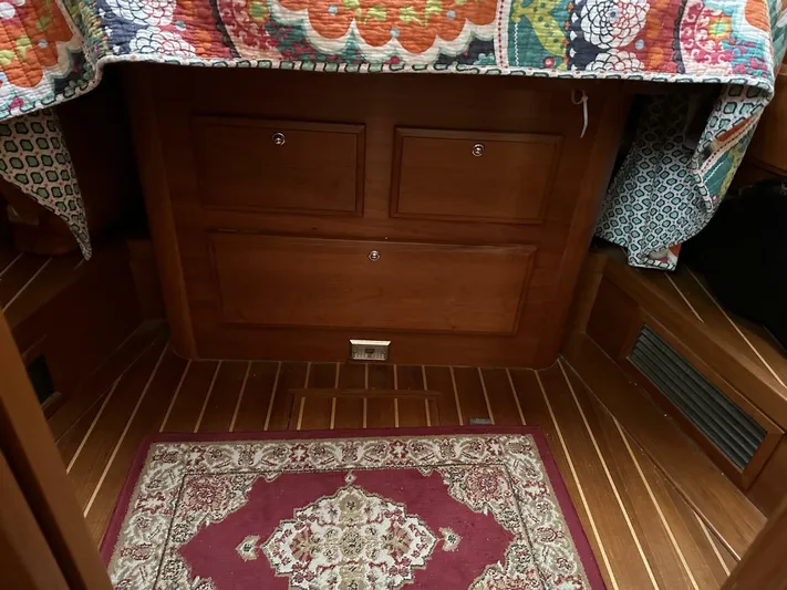 Blue Goose Yacht Photos Pics Interior of 2003 Sabre 36 Fly Bridge Sedan with wood paneling and patterned rug.