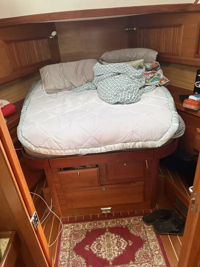 Blue Goose Yacht Photos Pics Cozy cabin interior of 2003 Sabre 36 Fly Bridge Sedan with bed and wooden furnishings.