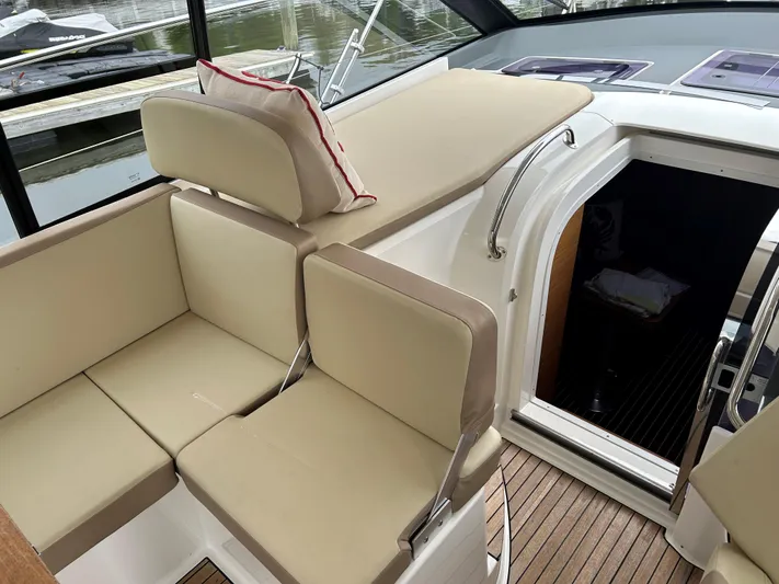  Yacht Photos Pics 2017 Bavaria S36 Coupe interior with beige seating and wooden flooring.