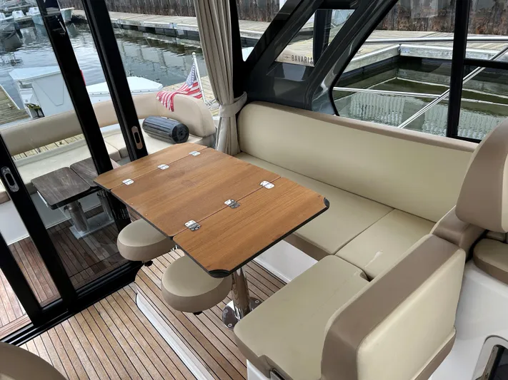  Yacht Photos Pics Interior of 2017 Bavaria S36 Coupe with beige seating and wooden table.