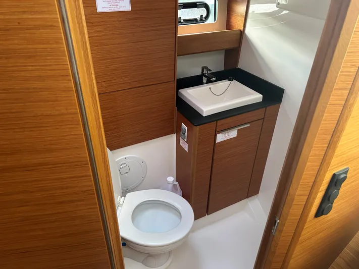  Yacht Photos Pics Bathroom interior of 2017 Bavaria S36 Coupe with wooden cabinetry and modern fixtures.