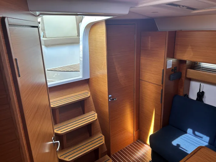  Yacht Photos Pics Interior of 2017 Bavaria S36 Coupe with wooden stairs and seating area.