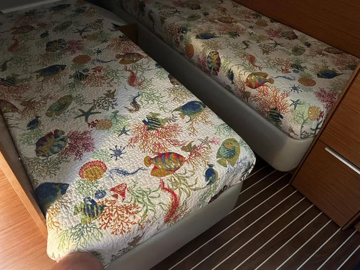  Yacht Photos Pics Twin beds with colorful marine-themed bedding in a 2017 Bavaria S36 Coupe.