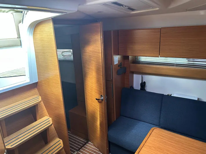  Yacht Photos Pics Interior of 2017 Bavaria S36 Coupe yacht with wooden finish and blue seating.