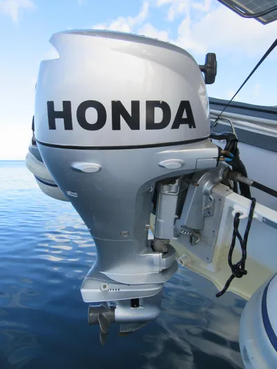 Lady Ana Yacht Photos Pics Silver Honda outboard motor on a Bali 4.1 boat, 2020 model, against a calm sea backdrop.