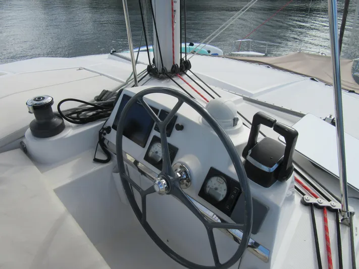 Lady Ana Yacht Photos Pics Steering wheel and controls of a 2020 Bali 4.1 catamaran on calm water.