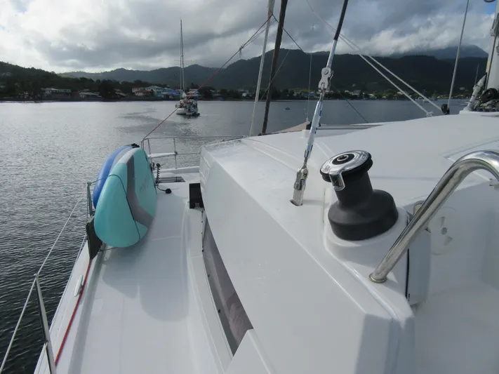 Lady Ana Yacht Photos Pics Sailboat deck view with paddleboard, Bali 4.1 model, anchored in scenic bay.