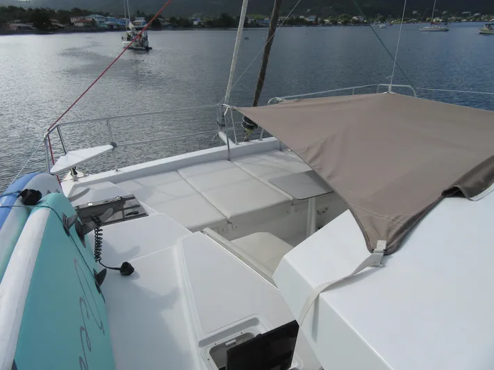Lady Ana Yacht Photos Pics Bali 4.1 catamaran deck with sunshade, anchored in a serene bay, 2020 model.