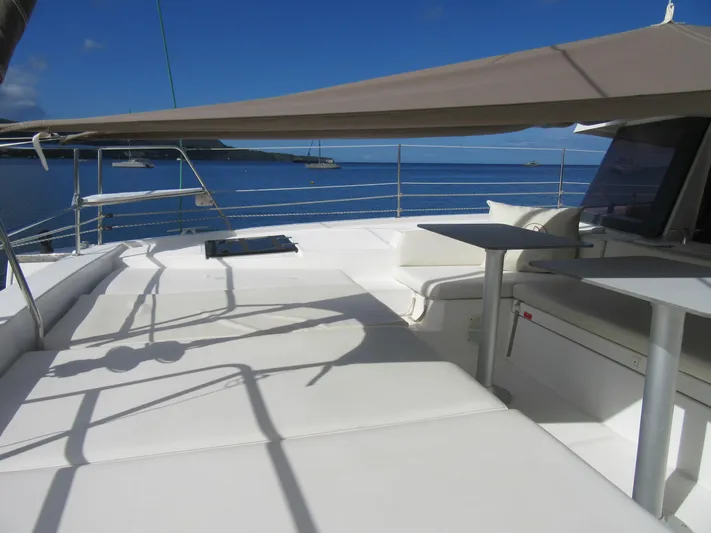 Lady Ana Yacht Photos Pics Luxurious Bali 4.1 catamaran deck with seating, table, and ocean view, 2020 model.