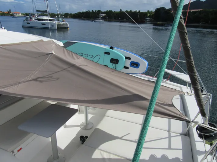 Lady Ana Yacht Photos Pics Catamaran Bali 4.1 with sunshade and paddleboard on calm water, 2020 model.