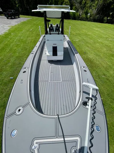  Yacht Photos Pics 2021 Orion 29CC boat on grass, showcasing sleek design and modern features.