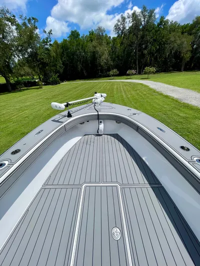  Yacht Photos Pics 2021 Orion 29CC boat on grassy lawn with clear blue sky background.