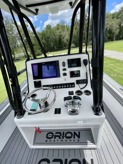  Yacht Photos Pics Cockpit of 2021 Orion 29CC boat with steering wheel and navigation controls.