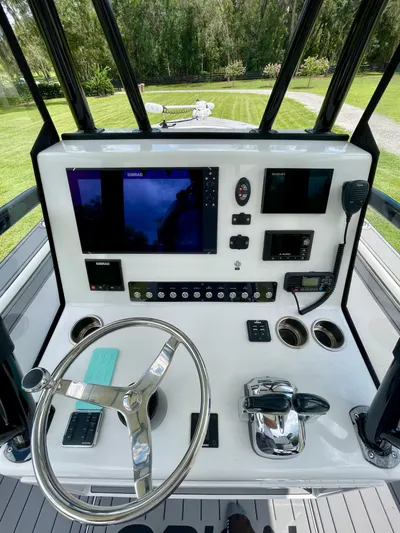  Yacht Photos Pics Control panel of 2021 Orion 29CC boat with steering wheel and navigation equipment.