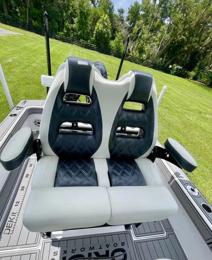  Yacht Photos Pics Luxury seating on 2021 Orion 29CC boat, featuring diamond-stitched upholstery and armrests.