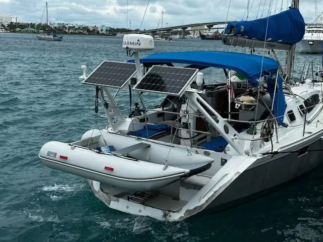 Monica Yacht Photos Pics Sailboat Alubat Ovni 395 Centerboard 2006 with solar panels and dinghy on water.