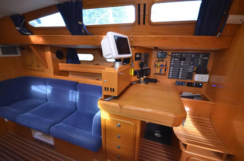 Monica Yacht Photos Pics Interior of 2006 Alubat Ovni 395 Centerboard yacht with blue seating and navigation station.