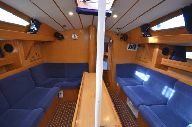 Monica Yacht Photos Pics Interior of 2006 Alubat Ovni 395 Centerboard yacht with blue seating and wooden finishes.