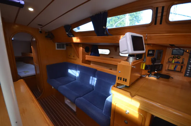 Monica Yacht Photos Pics Interior of 2006 Alubat Ovni 395 Centerboard yacht with blue seating and navigation equipment.