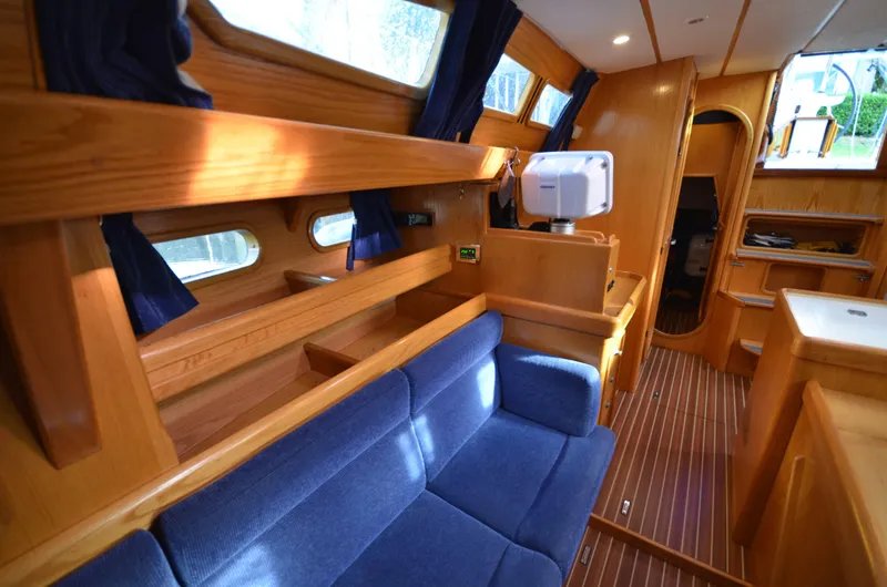 Monica Yacht Photos Pics Interior of 2006 Alubat Ovni 395 Centerboard yacht with blue seating and wooden finishes.