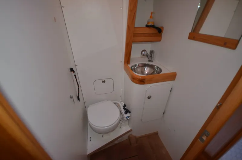 Monica Yacht Photos Pics Bathroom interior of 2006 Alubat Ovni 395 Centerboard yacht, featuring sink and toilet.