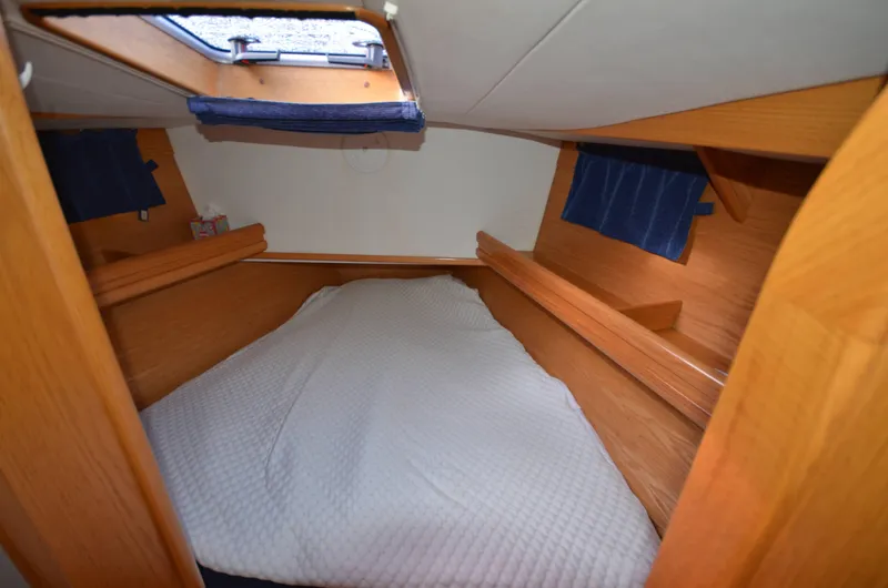 Monica Yacht Photos Pics Cozy cabin interior of 2006 Alubat Ovni 395 Centerboard sailboat with wooden finish.