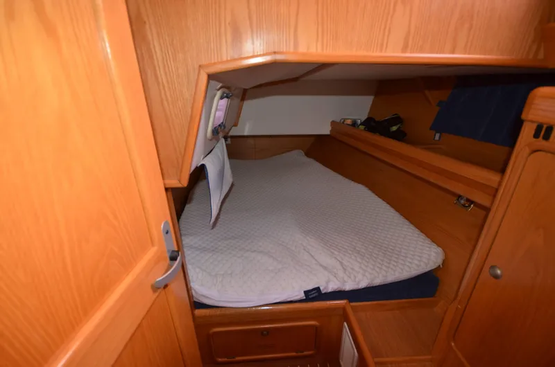 Monica Yacht Photos Pics Cozy cabin interior of 2006 Alubat Ovni 395 Centerboard sailboat with wooden finish.