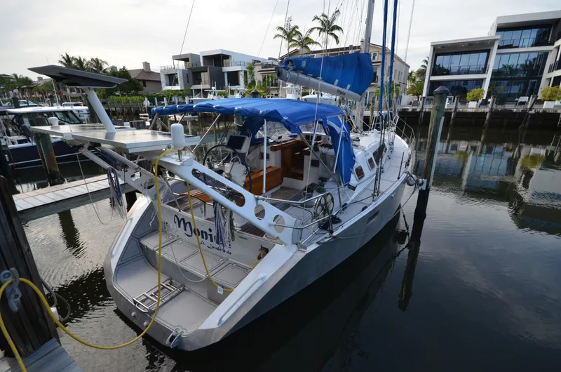 Monica Yacht Photos Pics 2006 Alubat Ovni 395 Centerboard yacht docked at a marina with blue canopy.