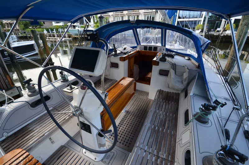 Monica Yacht Photos Pics 2006 Alubat Ovni 395 Centerboard sailboat cockpit with steering wheel and navigation equipment.