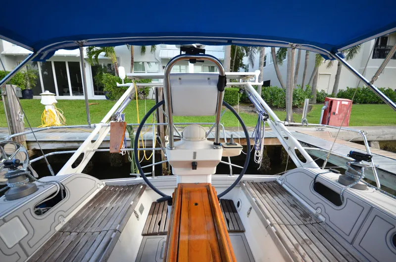 Monica Yacht Photos Pics 2006 Alubat Ovni 395 Centerboard sailboat cockpit with steering wheel and wooden seating.