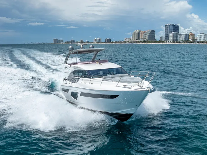  Yacht Photos Pics 2018 Princess F55 yacht cruising near city skyline on a sunny day.