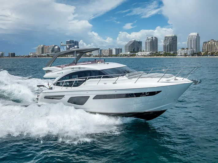  Yacht Photos Pics 2018 Princess F55 yacht cruising near city skyline on a sunny day.