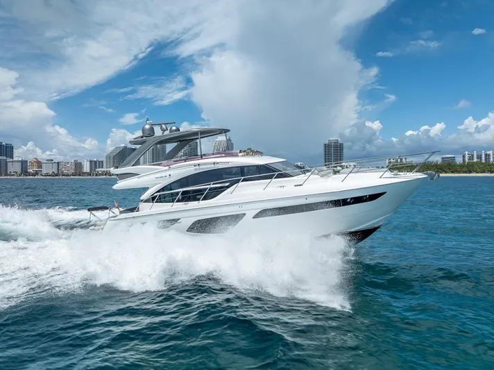  Yacht Photos Pics Luxurious 2018 Princess F55 yacht cruising on blue ocean near city skyline.