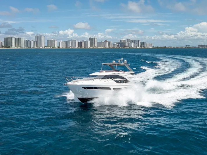  Yacht Photos Pics 2018 Princess F55 yacht cruising on blue ocean near city skyline.