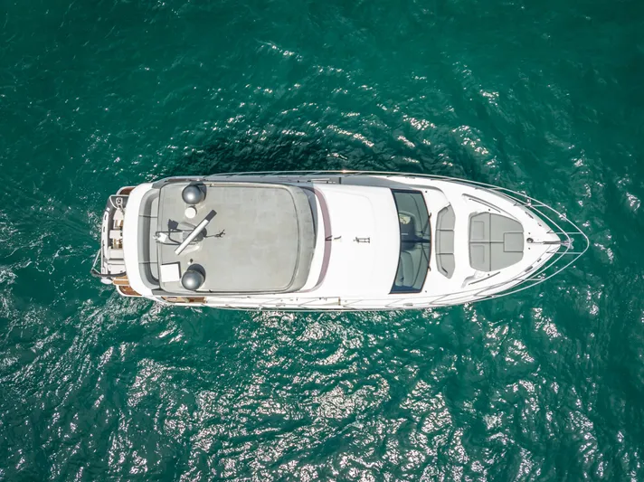  Yacht Photos Pics Aerial view of 2018 Princess F55 yacht on turquoise water.