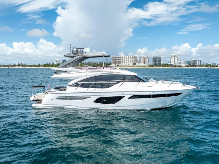  Yacht Photos Pics Luxurious 2018 Princess F55 yacht cruising on blue ocean near city skyline.