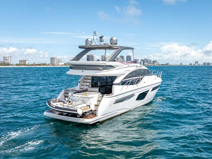  Yacht Photos Pics Luxurious 2018 Princess F55 yacht cruising on blue ocean near city skyline.