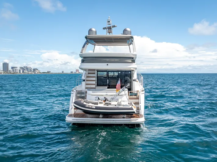  Yacht Photos Pics Luxury Princess F55 yacht on open sea, 2018 model, with city skyline in background.