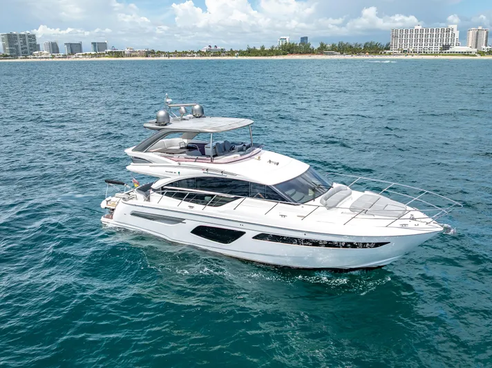  Yacht Photos Pics Luxurious 2018 Princess F55 yacht cruising on blue ocean near city skyline.