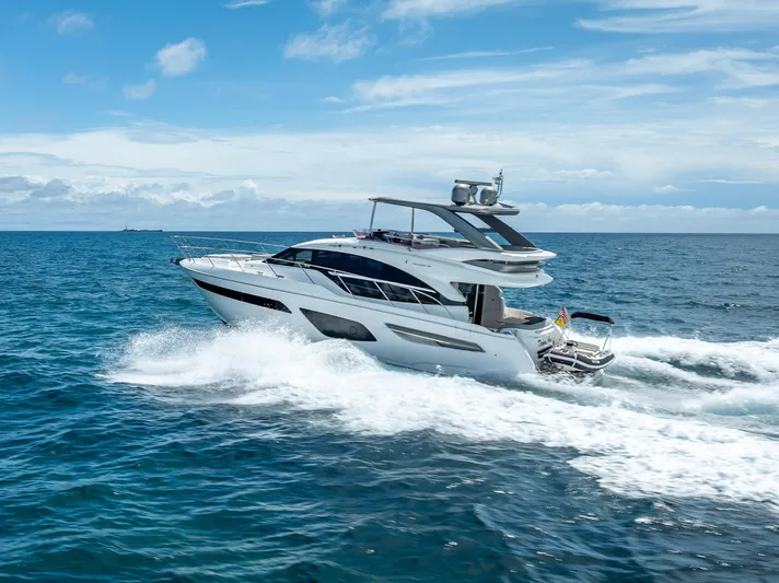  Yacht Photos Pics Luxurious 2018 Princess F55 yacht cruising on open sea under clear blue sky.