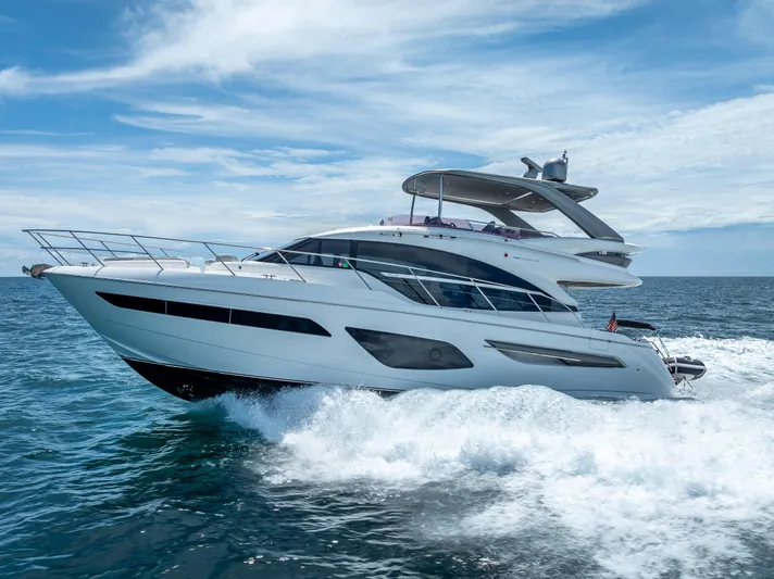  Yacht Photos Pics Luxurious 2018 Princess F55 yacht cruising on open sea under clear skies.