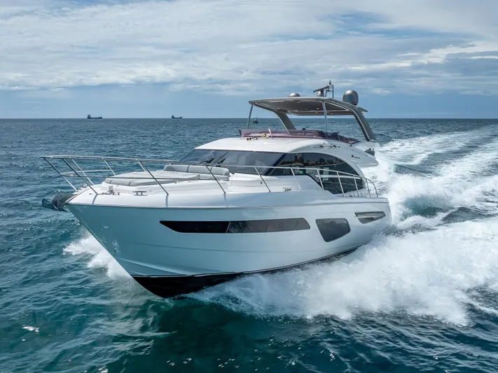  Yacht Photos Pics 2018 Princess F55 yacht cruising on open sea, creating waves under a cloudy sky.