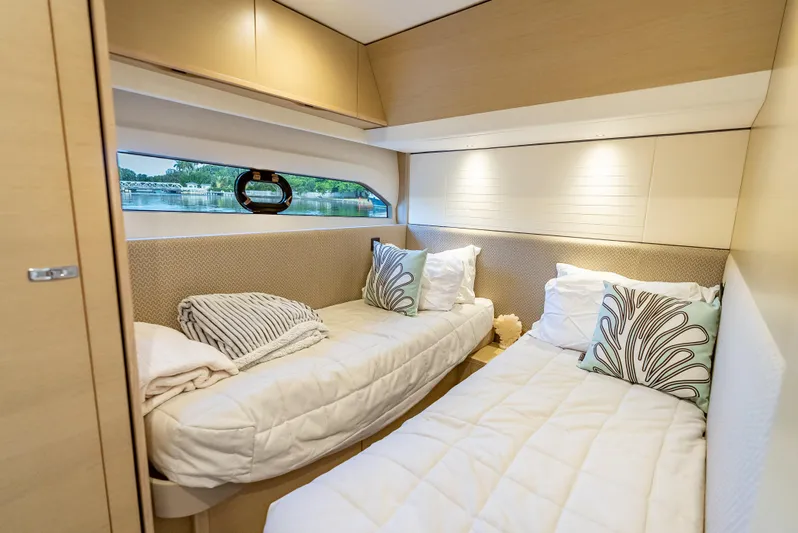  Yacht Photos Pics Luxurious cabin interior of 2018 Princess F55 yacht with twin beds and scenic window view.