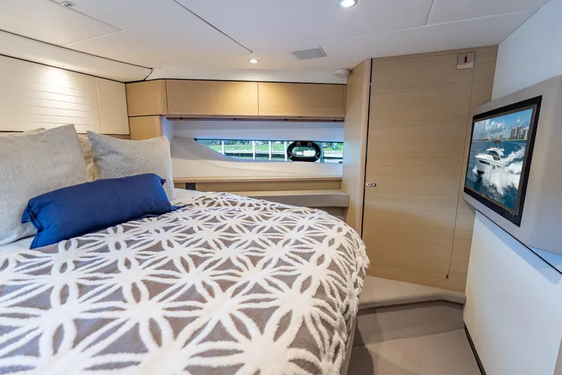  Yacht Photos Pics Luxurious cabin interior of 2018 Princess F55 yacht with stylish bedding and wall-mounted TV.