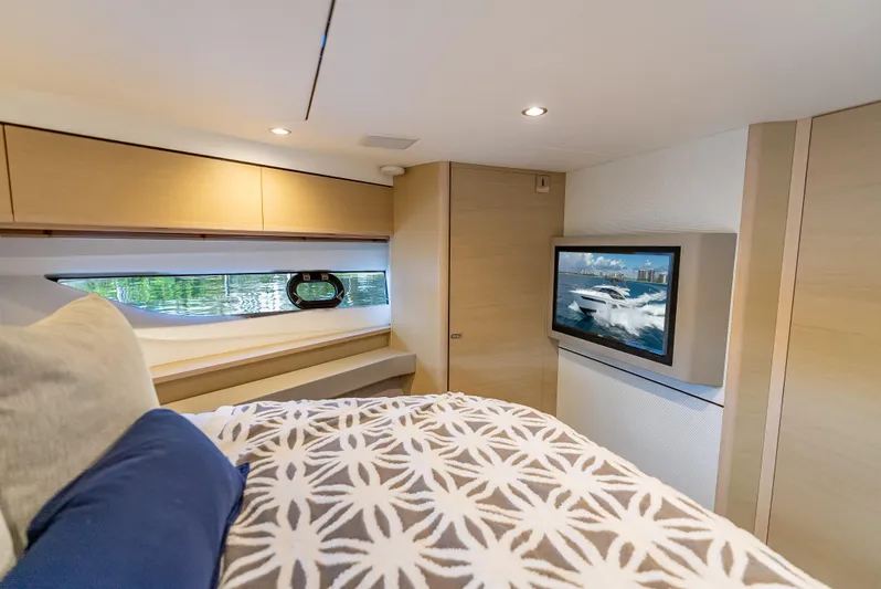  Yacht Photos Pics Luxurious cabin interior of 2018 Princess F55 yacht with TV and stylish bedding.