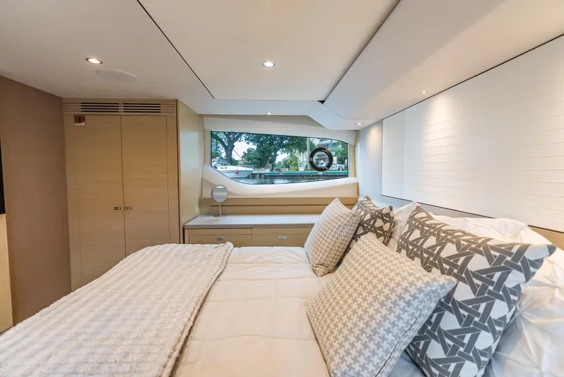  Yacht Photos Pics Luxurious bedroom interior of 2018 Princess F55 yacht with elegant bedding and scenic window view.