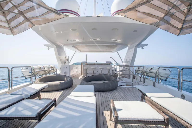 Safad Yacht Photos Pics Luxurious deck of 2015 Benetti 121 yacht with sun loungers and ocean view.
